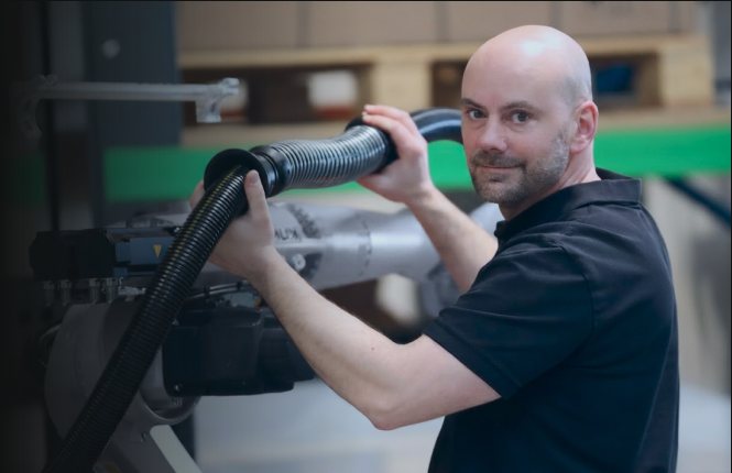 Employee performing machine maintenance